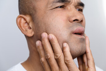 The man has facial swelling due to an allergic reaction to triggers such as insect bites stings