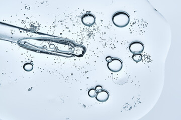 The texture of a serum or cosmetic gel with a pipette. Angle from below.