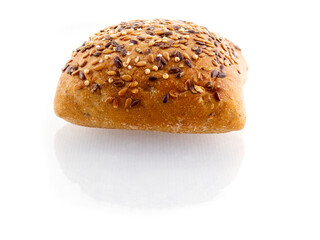 One small premium roll with seeds and grain on white background with reflection. Fine bakery product made from high quality premium ingredients, Small taste crusty bread.