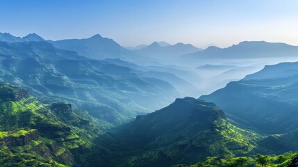 Misty green mountains ascend into blue