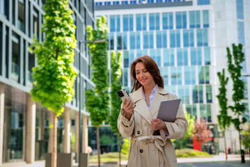 Businesswoman on her way to the office using her cell phone and having a business call