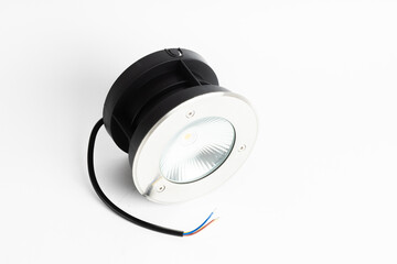 Compact Round LED Spotlight with Exposed Wires Isolated on White Background

