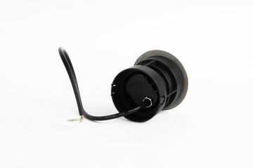 Black Round Inground Outdoor LED Light with Side Openings and Exposed Wires Isolated on White Background

