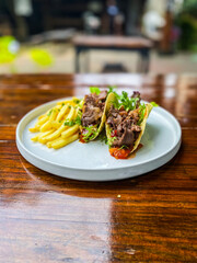 A beautifully presented dish of quesadillas served with fresh salsa and crispy fries, ideal for casual dining and sharing.