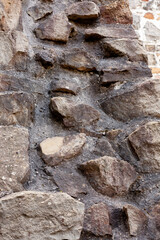 Rough stone wall with uneven surface texture
