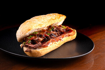 juicy open duck magret sandwich on Italian baguette with bacon and spices macro close-up