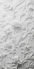 Intricate white floral relief on textured wall surface