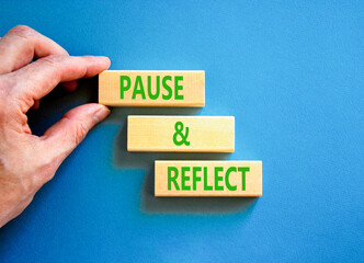 Pause and reflect symbol. Concept words Pause and reflect on beautiful block. Businessman's hand....