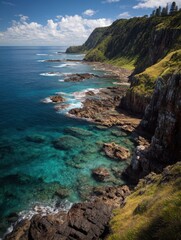 Fototapeta premium Breathtaking aerial view of a rugged coastline with turquoise water and lush greenery creating a serene and captivating landscape from a high angle perspective