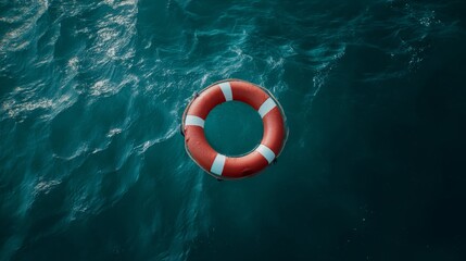 Bright red lifebuoy on teal ocean water for safety and rescue