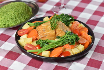 codfish typical Portuguese dish baked cod with onion garlic peppers and potatoes rustic Portuguese food salted fish cooked olive oil