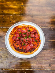 A beautifully presented bowl of salsa featuring a mix of colorful vegetables, perfect for sharing at gatherings.