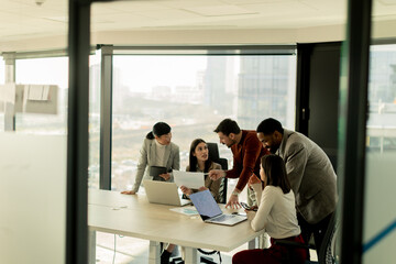 Collaboration among diverse professionals in modern office space during a strategic meeting