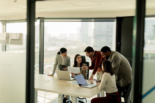 Collaboration among diverse professionals in modern office space during a strategic meeting