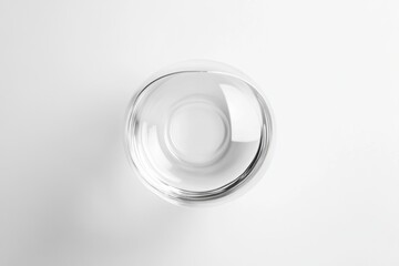 Minimalist Clear Glass Bowl on White Background Clean Aesthetic Top Down View Studio Shot Simplicity and Elegance in Still Life Photography Contemporary Style