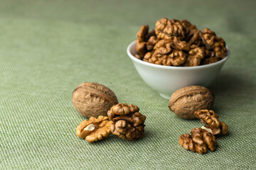 Walnuts close-up on table with green tablecloth