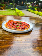 A colorful bowl of salsa filled with fresh ingredients, perfect for enhancing tacos or as a dip for snacks.