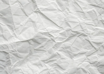 Crumpled white paper texture on a clean, blank surface, featuring wrinkles against a white background.