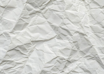 Fototapeta premium Crumpled white paper texture on a clean, blank surface, featuring wrinkles against a white background.