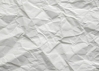 Obraz premium Crumpled white paper texture on a clean, blank surface, featuring wrinkles against a white background.