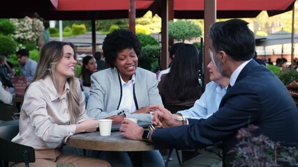 Business partners closing a deal at an outdoor cafe