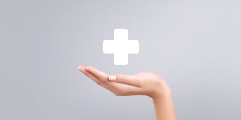 Obraz premium Open hand with medical cross symbol on grey background
