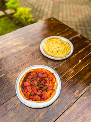 A fresh bowl of salsa paired with cheesy pasta, creating a perfect balance of flavors for any meal.