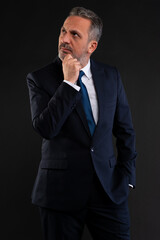 Businessman thinking and looking up in curiosity.