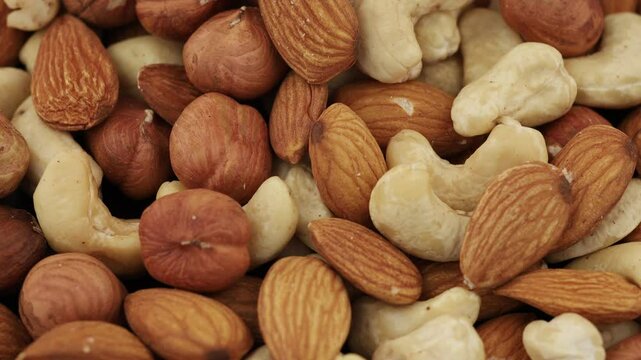 Assorted nuts displayed together, showcasing almonds, cashews, and hazelnuts, perfect for snacking or cooking