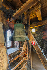 Historic church bells inside medieval tower in Toruń Old Town, Poland..