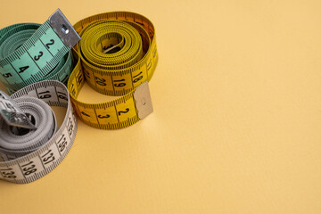 Measuring tape on a light background. Tool for measuring length and volume. Tape for measuring in the clothing industry or the volume of the human body