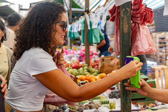 Brazilian Woman Paying with a Card at Street Market