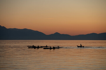 rowing at the ocean during sunset