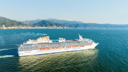 Close up of cruise ship and in the background the beautiful city of puerto vallarta, mexico