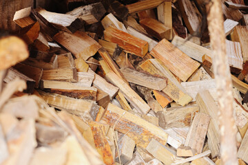 Chopped firewood ready for use. Natural wood texture. Rustic background. Wooden logs for fireplace. Energy from nature. Warmth and comfort. Traditional heating method. Stack of dry wood.