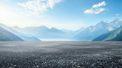A wide-angle ground with a clear sky and mountainous background for vehicles or products placement. Copy space image. Place for adding text or design