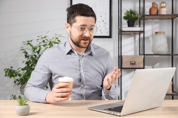 Online speaker streaming with laptop at table indoors