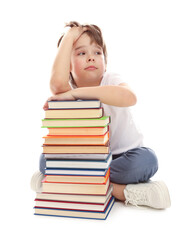 Upset boy with books on white background