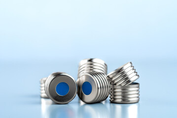 metallic caps with blue rubber septum for vials for gas chromatography measuring.