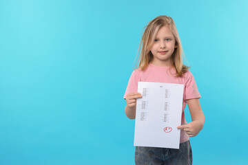 School grade. Little girl holding answer sheet with letter A and plus symbol on light blue...
