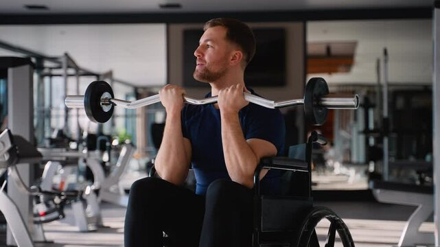 Man in wheelchair training biceps with curl bar