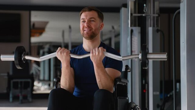 Man in wheelchair doing bicep curls with barbell