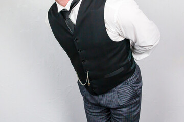Butler or Hotel Concierge in Formal Waistcoat Bowing in Polite Greeting. At Your Service.