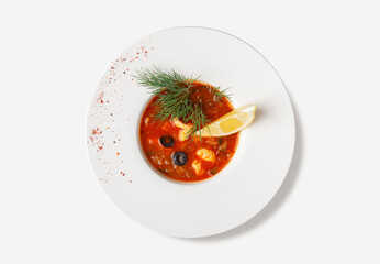 Top View of Seafood Solyanka with Lemon and Dill on White Plate