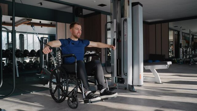 Man in wheelchair using cable machine for arm workout