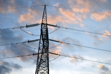 a large electricity pole at dusk