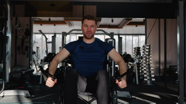 Wheelchair user training back with lat pulldown machine