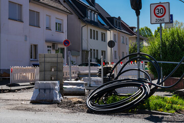 Fototapeta premium Building materials and utility cables were coiled on a city street