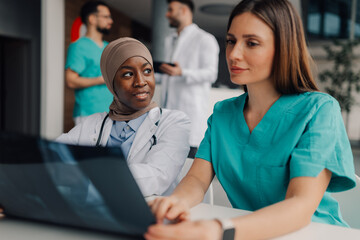 Doctors examining x ray image of foot in hospital