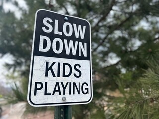 Slow Down Kids Playing Caution Road Sign